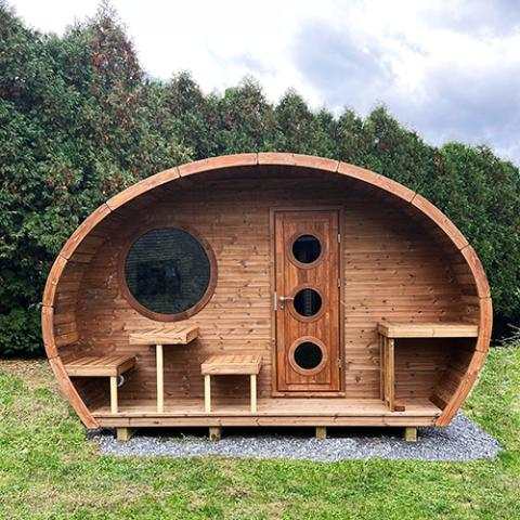 SaunaLife Model G11 spacious outdoor home sauna kit with two-room layout, large round windows, and wood-fired stove option