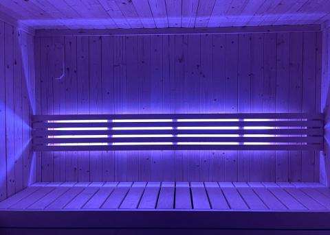 SaunaLife Mood Lighting RGB colored LED light bars glowing behind sauna backrests in Model X7 sauna with app control.