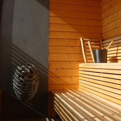 HUUM DROP 9.0kW wall-mounted sauna heater with stones and digital control panel