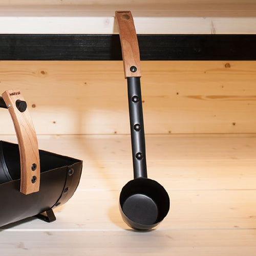Close up of Harvia sauna ladle with wood handle