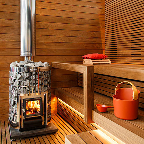 Wood-Burning Sauna Stove with Rocks and Fire in Sauna