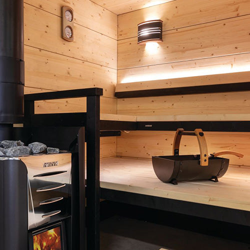 Sauna interior with Harvia stove and bucket