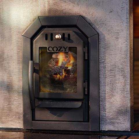 Handmade wood-burning Cozy Heat thru-wall sauna heater in black steel